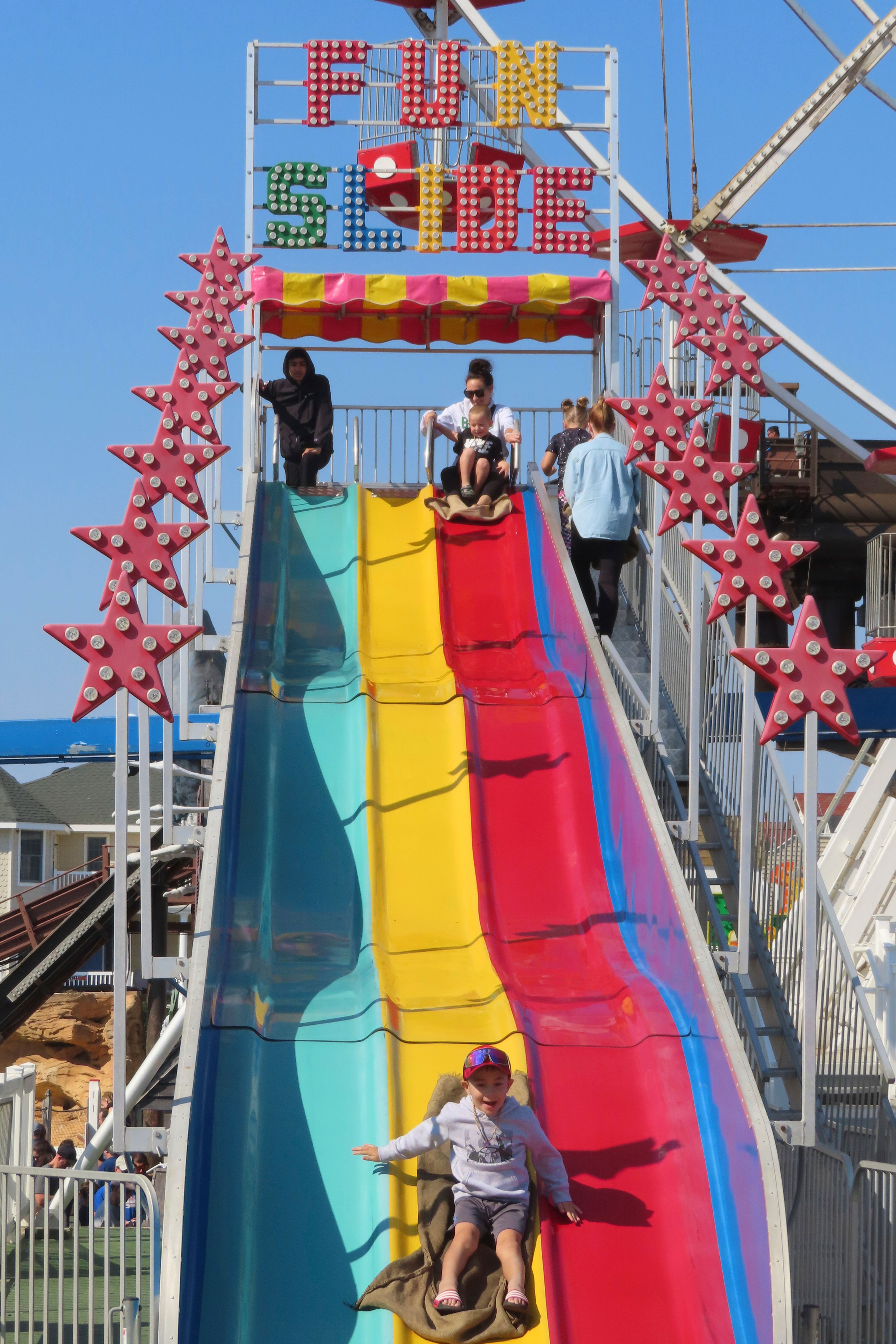 A child enjoys the Fun Slide at Gillian's Wonderland, the popular amusement park on the boardwalk in Ocean City, N.J., during its final day of operation before shutting down for good, Sunday, Oct. 13, 2024. (AP Photo/Wayne Parry)