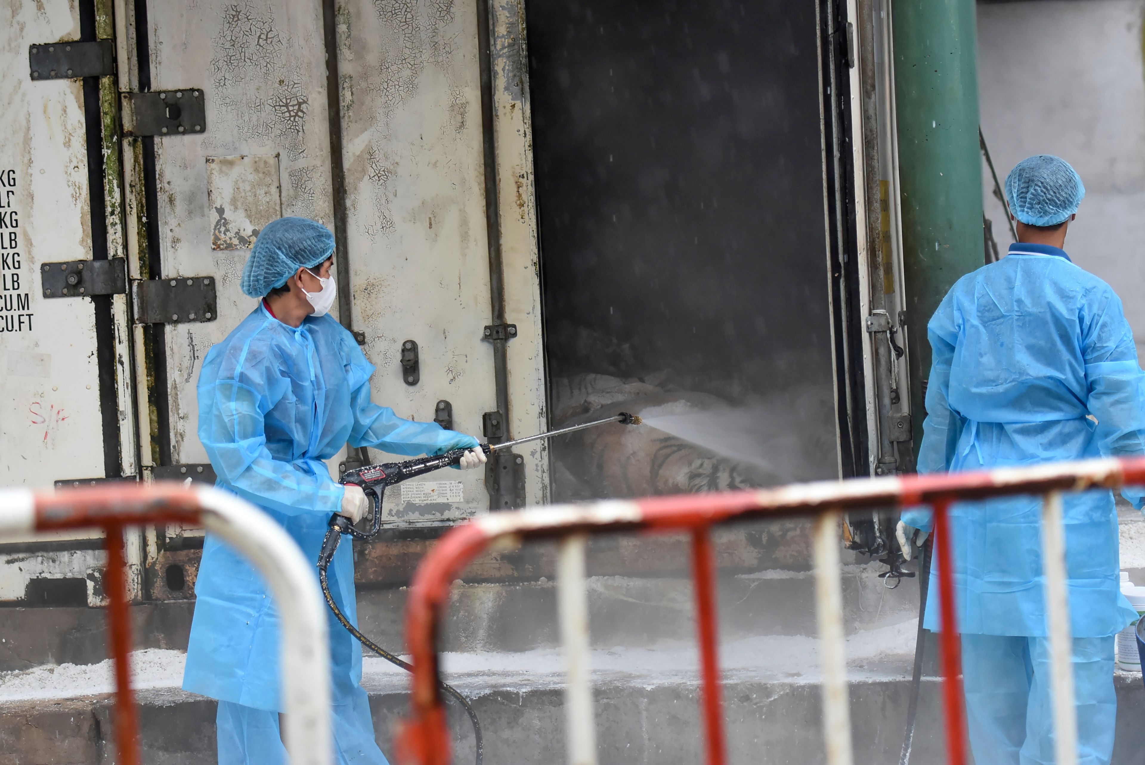 Animal health workers spray disinfectant after tigers died of bird flu at Dong Xoai zoo in Bien Hoa city, Vietnam on Thursday, Oct. 3, 2024. (Phuoc Tuan/VNExpress via AP)