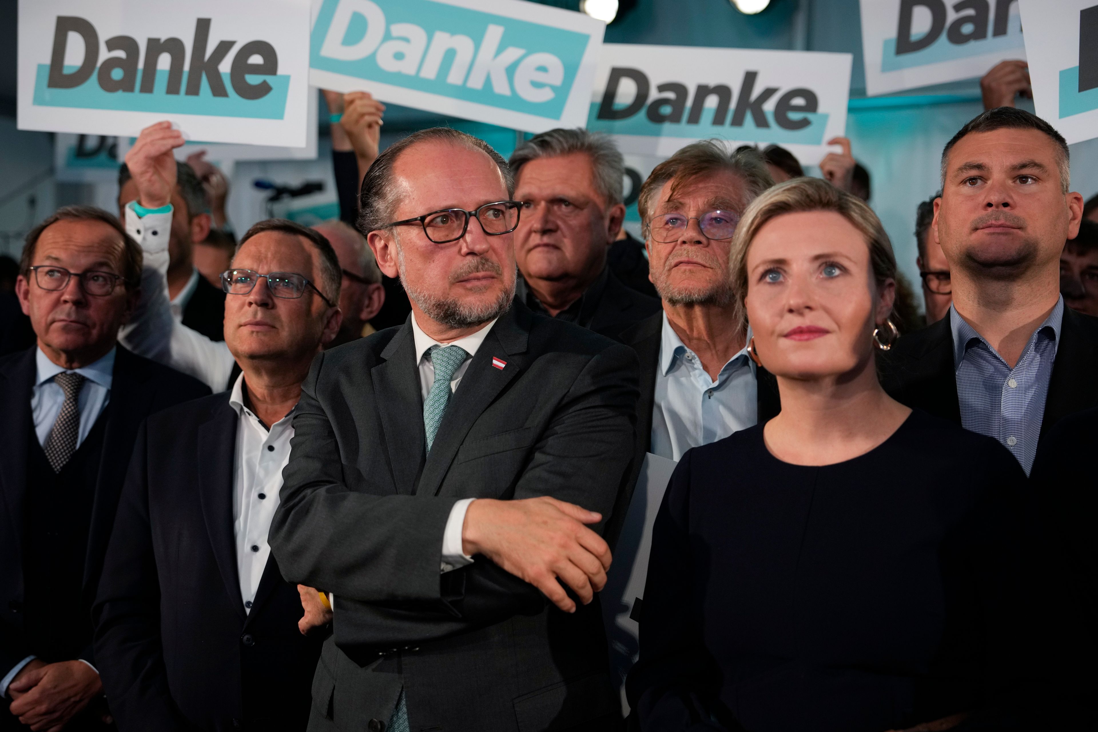 FILE - Austria's Foreign Minister Alexander Schallenberg, center left, and Susanne Raab of the at the OVP, Austrian People's Party, look on as supporters hold "Thank You" banners at the party headquarters in Vienna, Austria, Sunday, Sept. 29, 2024, after seeing the first electoral projections in the country's national election. (AP Photo/Andreea Alexandru, File)