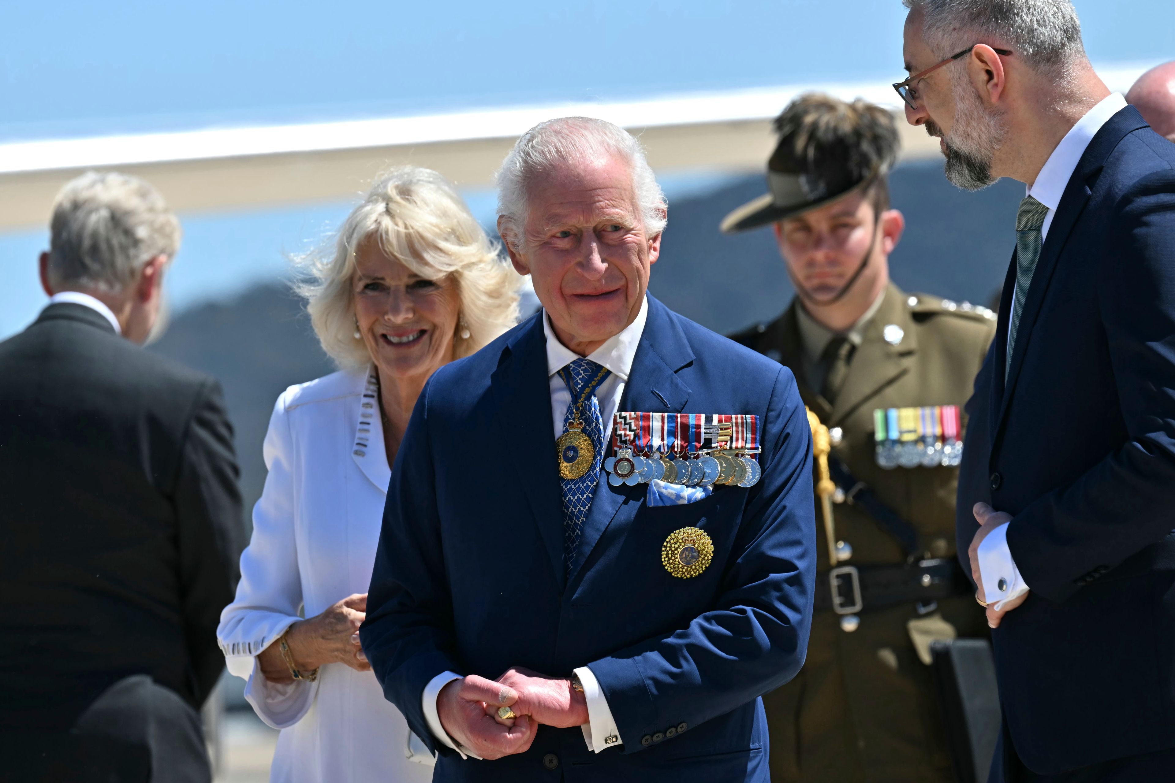 Britain's King Charles III, center, and Queen Camilla arrive at Defense Establishment Fairbairn in Canberra, Australia, Monday, Oct. 21, 2024. (Saeed Khan/Pool Photo via AP)