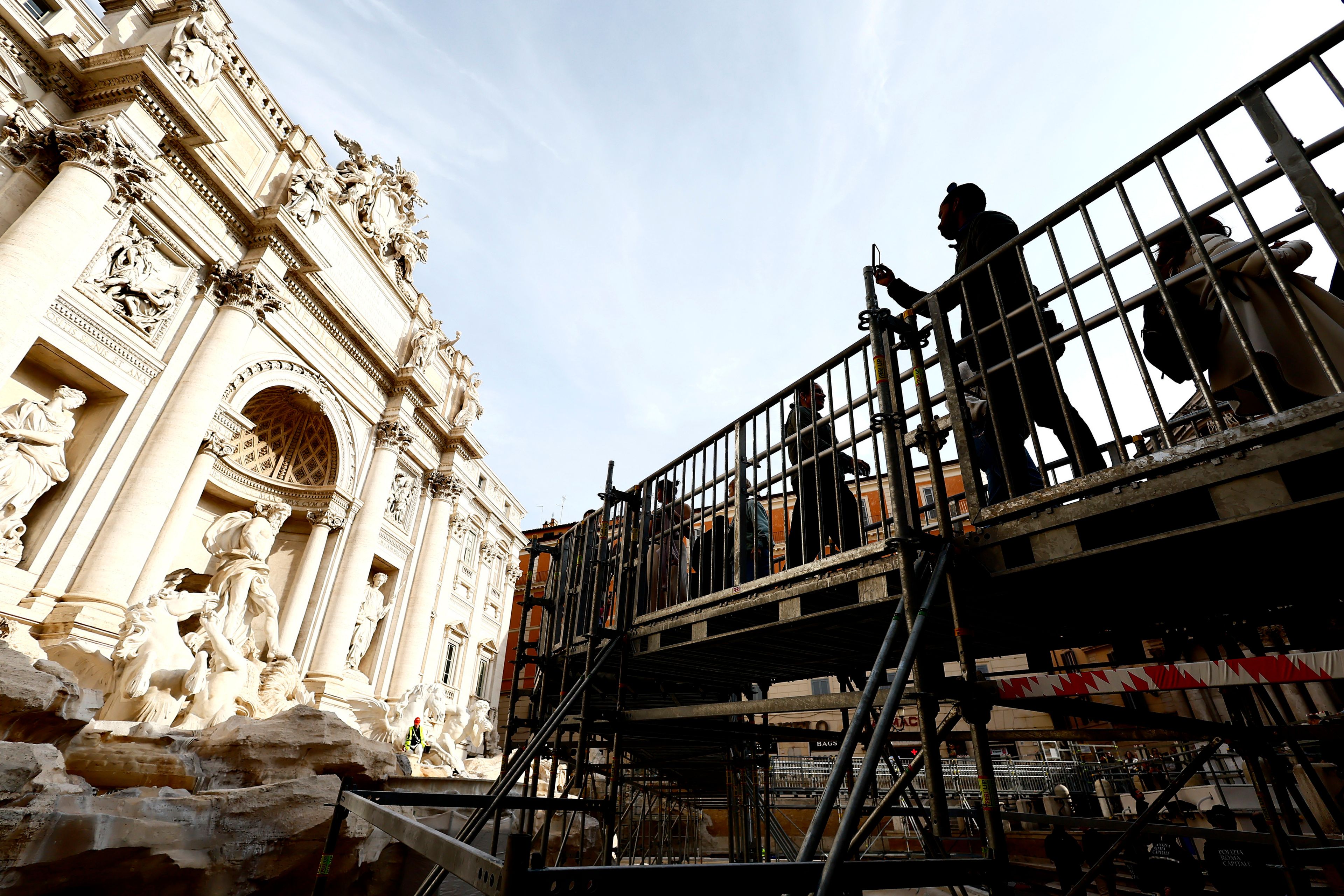 Tourists in Rome now have a walkway to visit the Trevi Fountain but can't toss coins