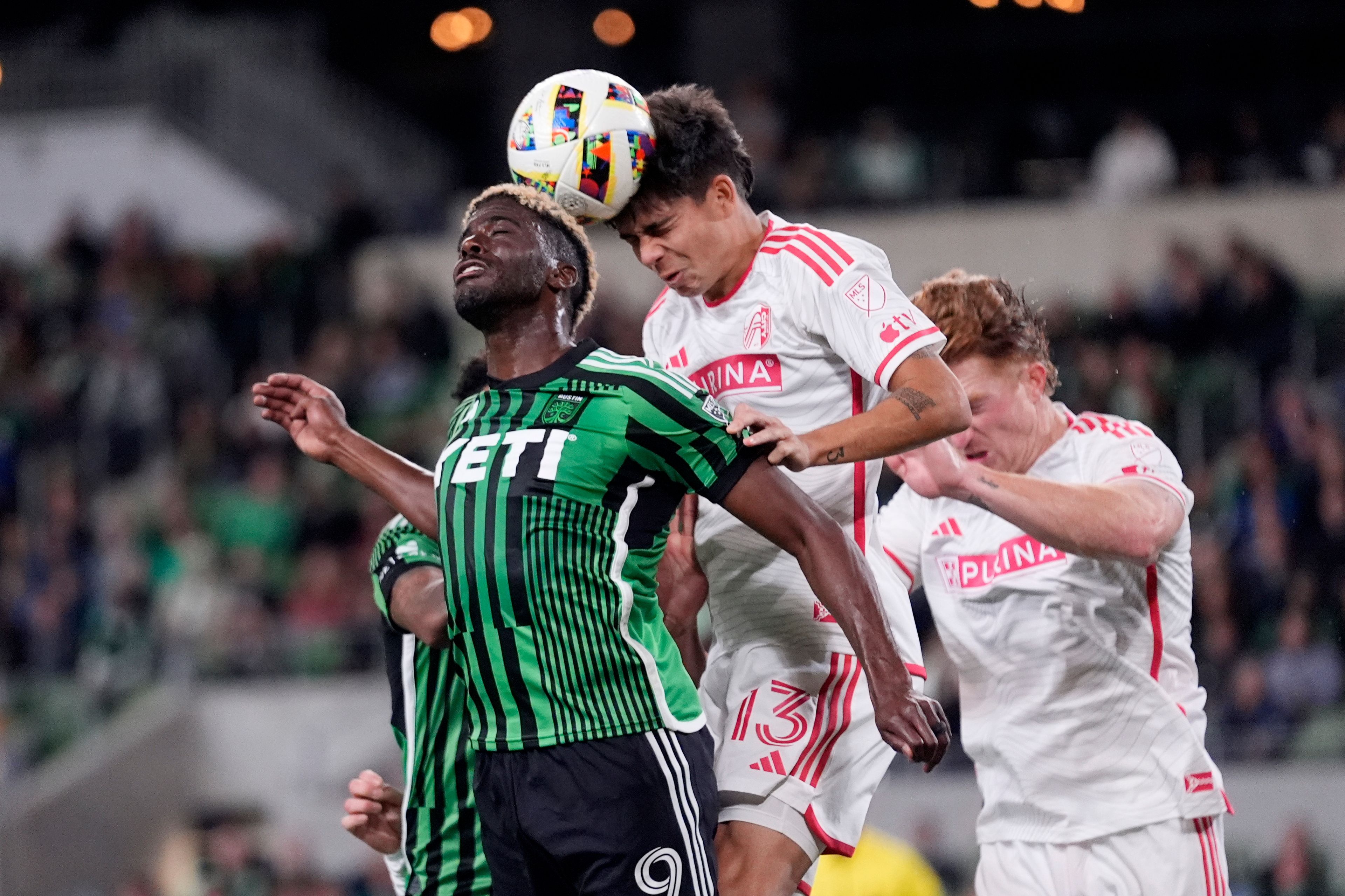 Austin FC forward Gyasi Zardes, left, and St. Louis City defender Anthony Markanich (13) leap for the ball during the first half of an MLS soccer match in Austin, Texas, Saturday, March 9, 2024. (AP Photo/Eric Gay)
