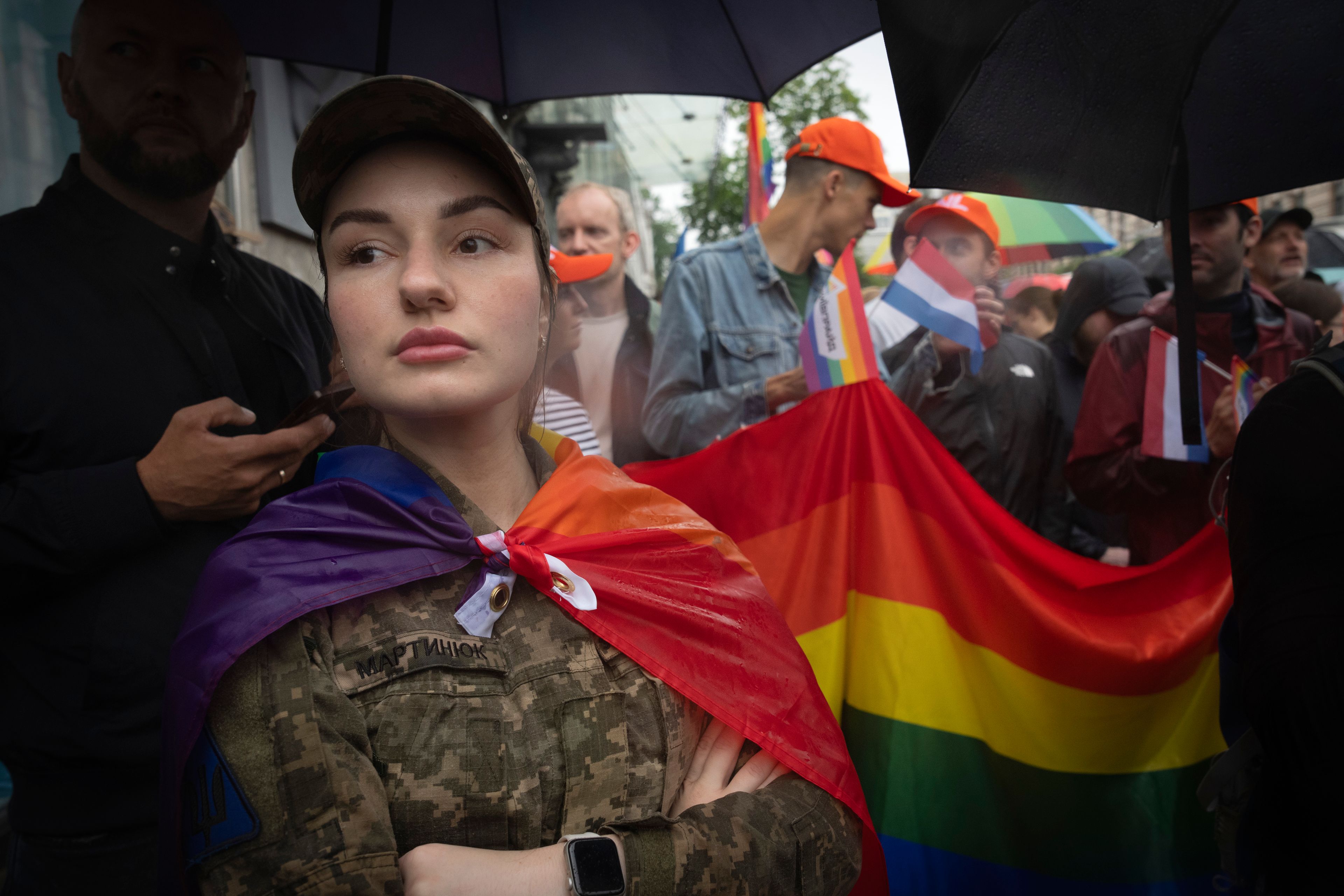 A woman soldier wrapped in the LGBTQ+ flag attends a Pride march in Kyiv, Ukraine, Sunday, June 16, 2024. (AP Photo/Efrem Lukatsky)