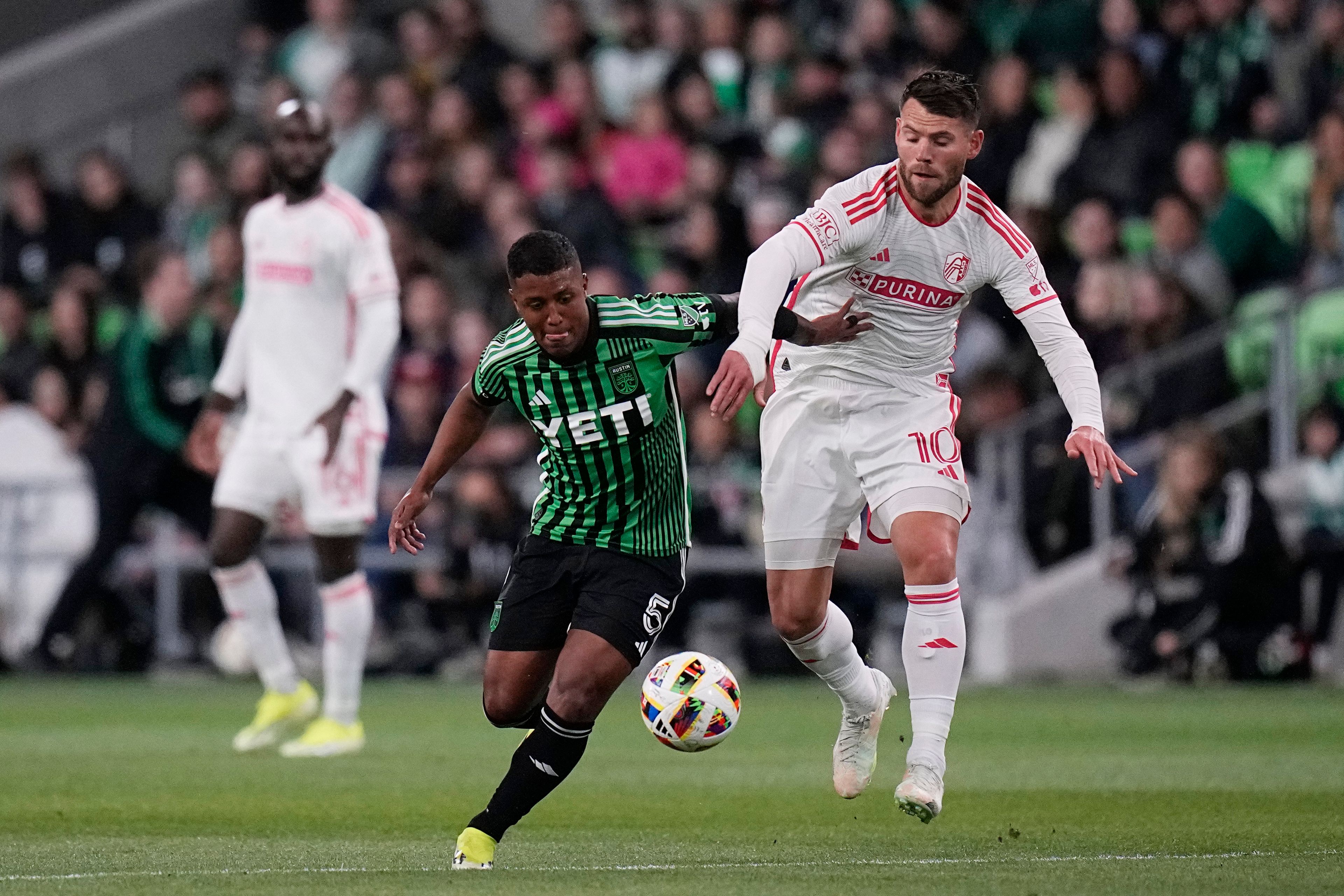 Austin FC midfielder Jhojan Valencia (5) and St. Louis City midfielder Eduard Lowen (10) compete for control of the ball during the first half of an MLS soccer match Saturday, March 9, 2024, in Austin, Texas. (AP Photo/Eric Gay)