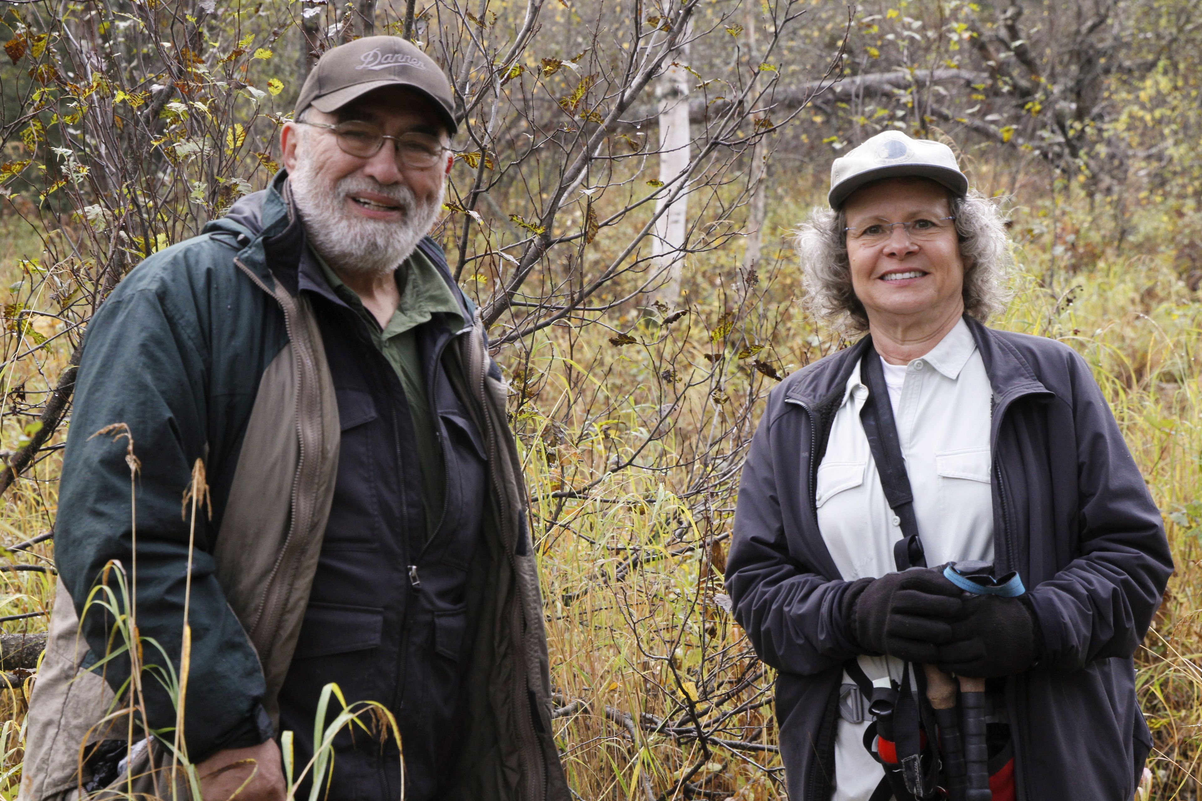 Joe Cantil, left, and Donna Gail Shaw, pose for a photo on Sept. 26, 2024, in Anchorage, Alaska. The two are the co-administrators of a Facebook group that features wildlife videos captured on their trail cameras very near a populated Anchorage neighborhood. (AP Photo/Mark Thiessen