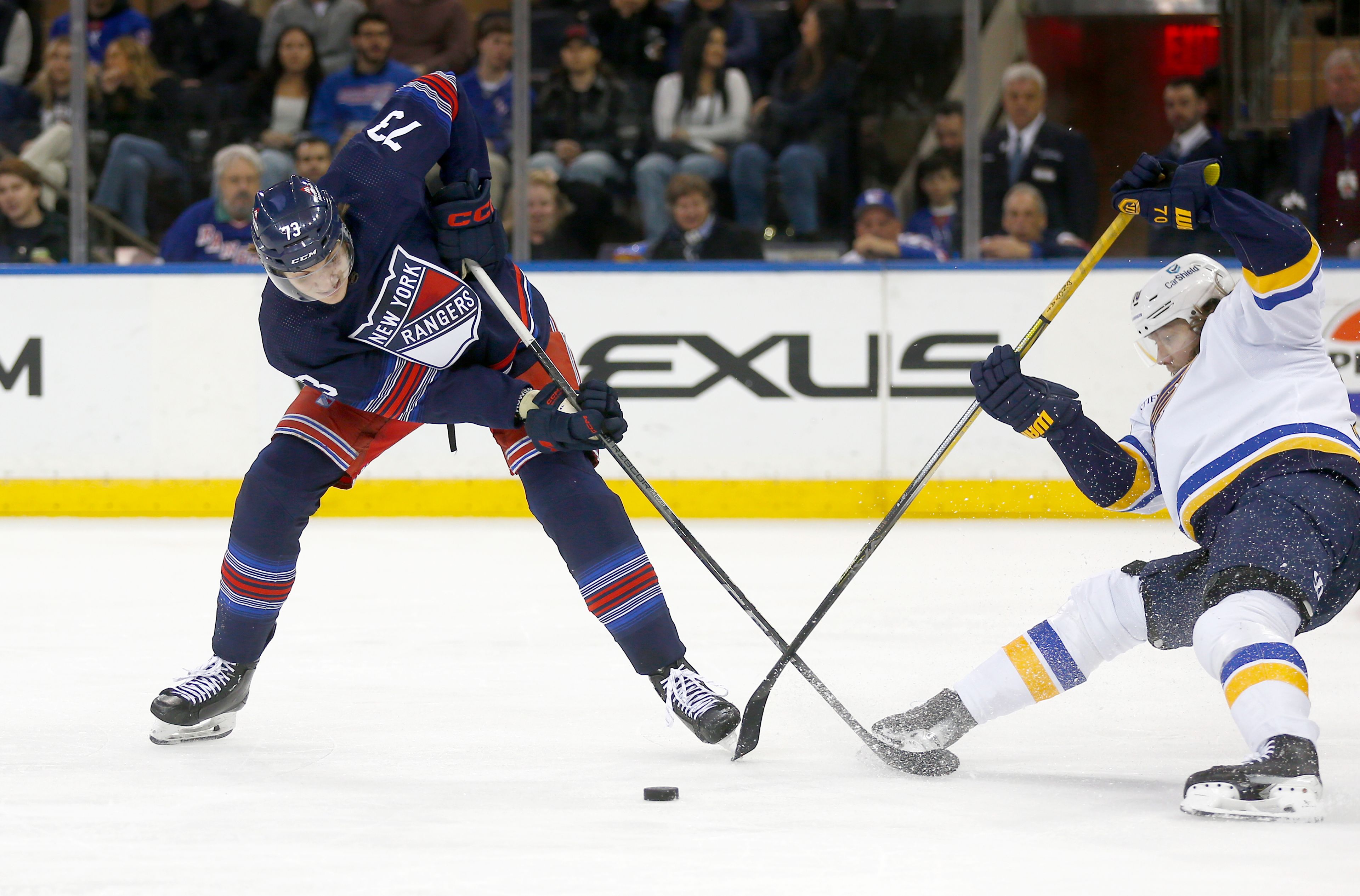 New York Rangers center Matt Rempe, left, and St. Louis Blues center Oskar Sundqvist, right, battle for the puck during the second period of an NHL hockey game Saturday, March 9, 2024, in New York. (AP Photo/John Munson)