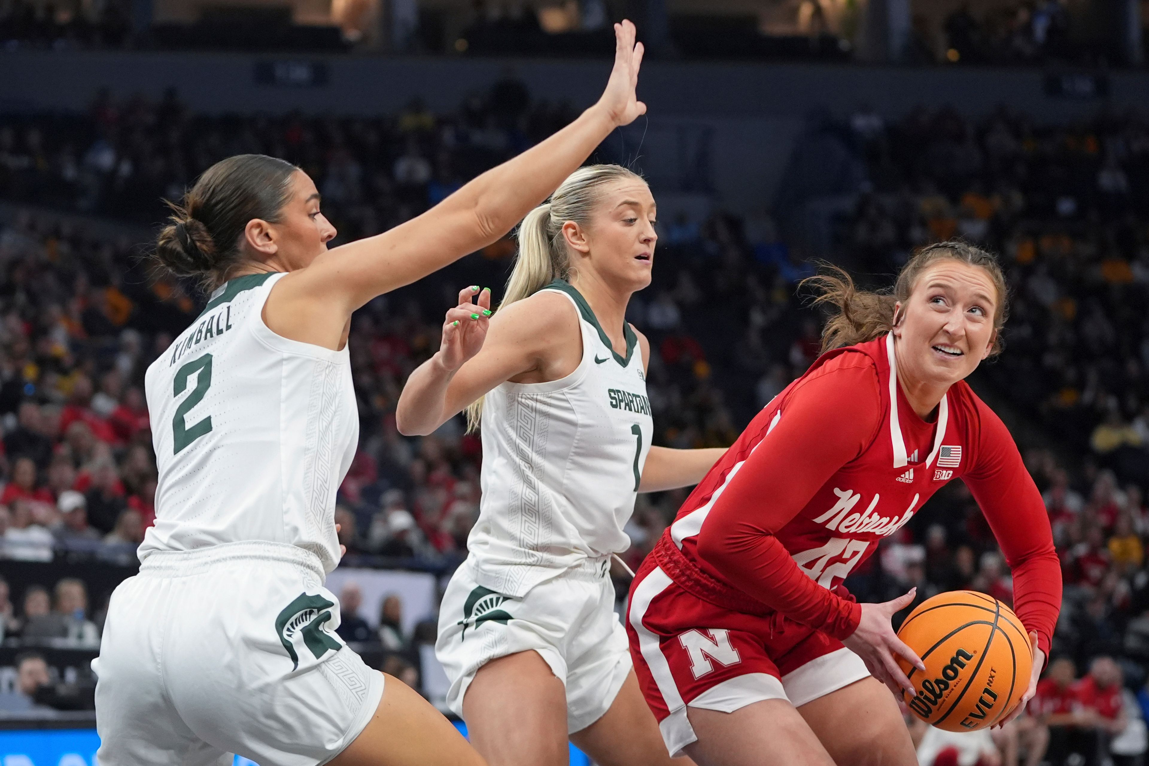 Nebraska guard Maddie Krull (42) handles the basketball as Michigan State guards Abbey Kimball (2) and Tory Ozment (1) defend during the first half of an NCAA college basketball quarterfinal game at the Big Ten women's tournament Friday, March 8, 2024, in Minneapolis. (AP Photo/Abbie Parr)