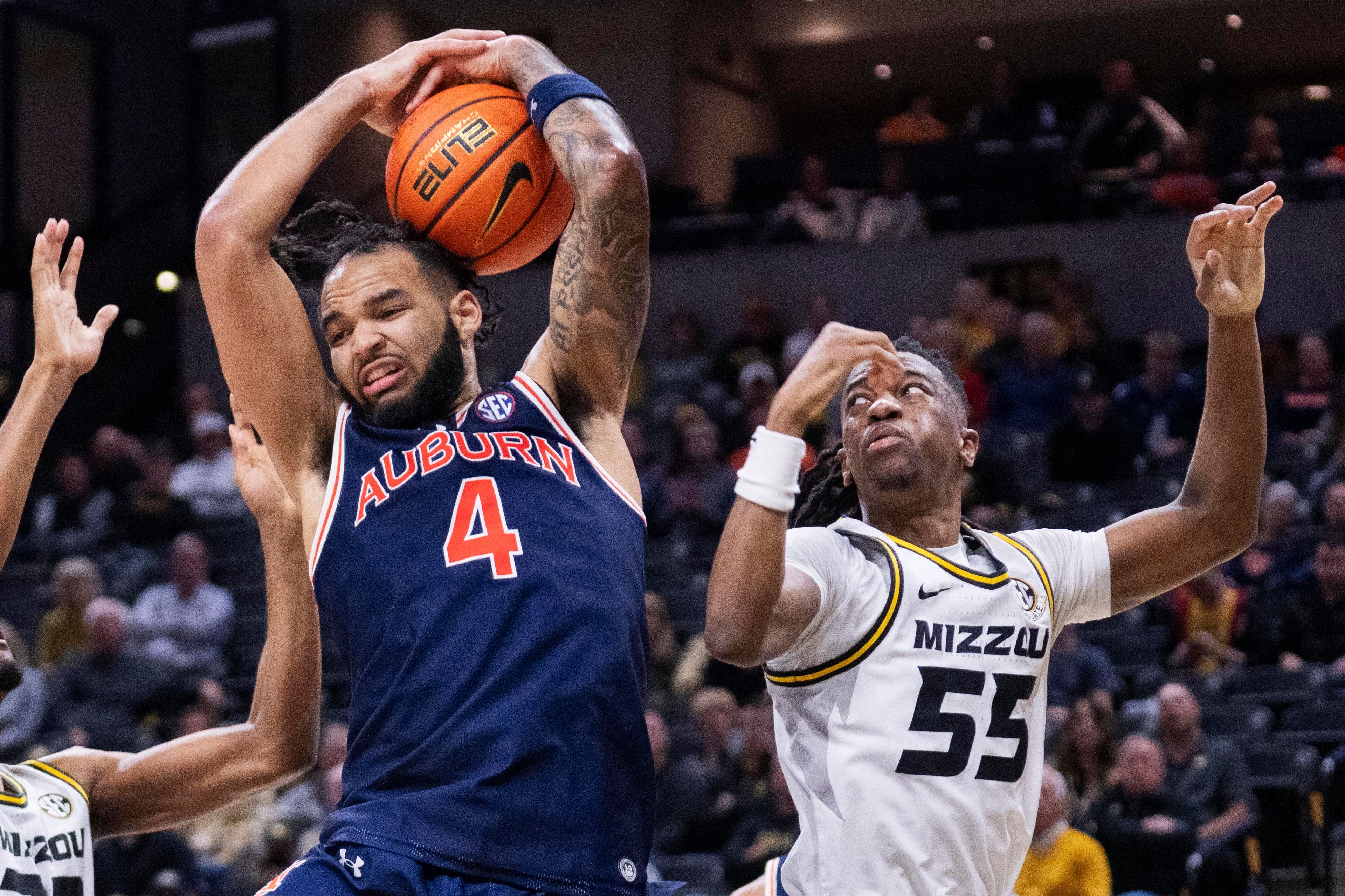 Auburn's Johni Broome, left, pulls down a rebound next to Missouri's Sean East II, right, during the second half of an NCAA college basketball game Tuesday, March 5, 2024, in Columbia, Mo. (AP Photo/L.G. Patterson)
