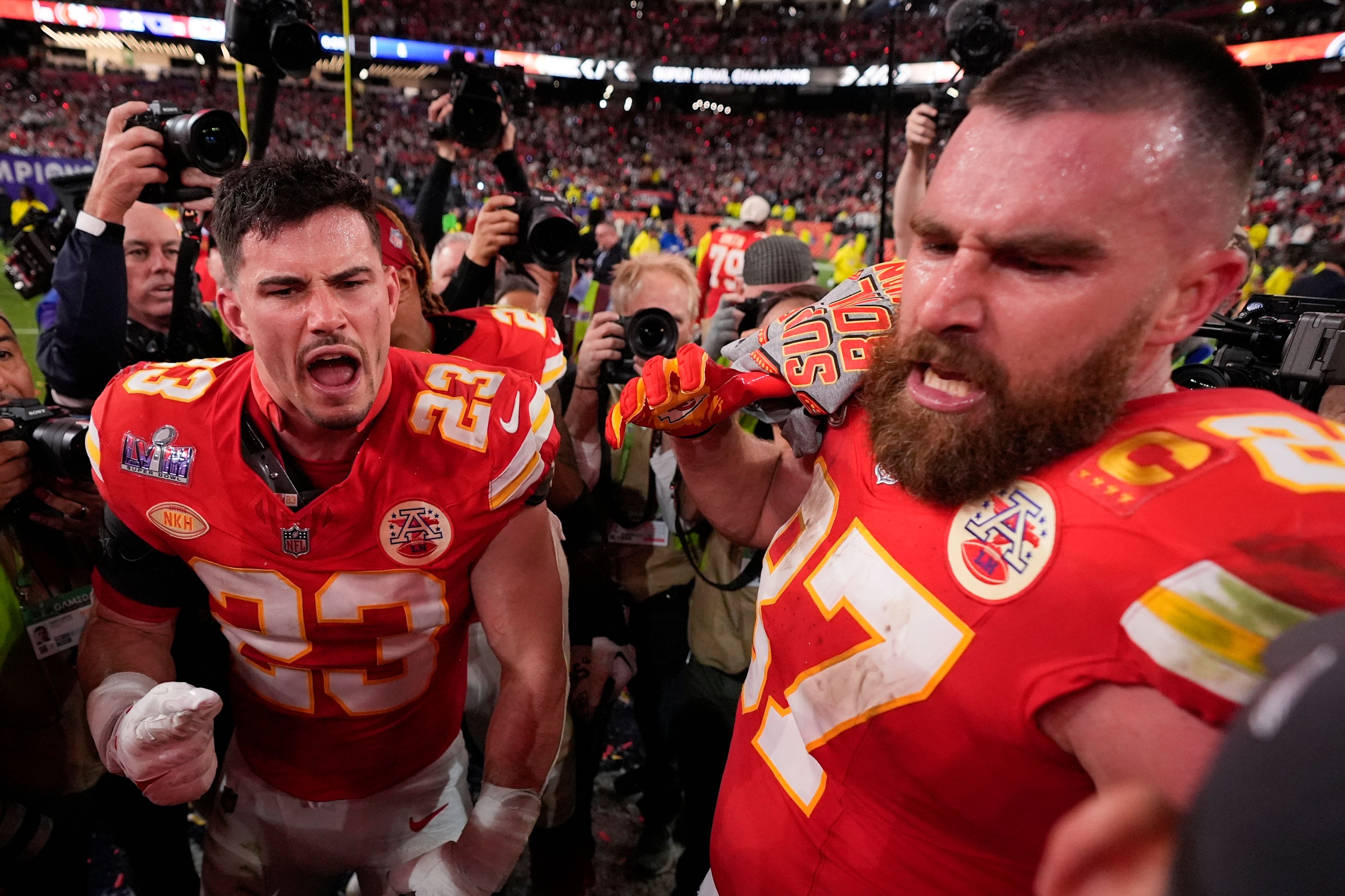 Kansas City Chiefs tight end Travis Kelce (87) and Kansas City Chiefs linebacker Drue Tranquill (23) celebrate after the NFL Super Bowl 58 football game against the San Francisco 49ers on Sunday, Feb. 11, 2024, in Las Vegas. The Kansas City Chiefs won 25-22 against the San Francisco 49ers. (AP Photo/Ashley Landis)