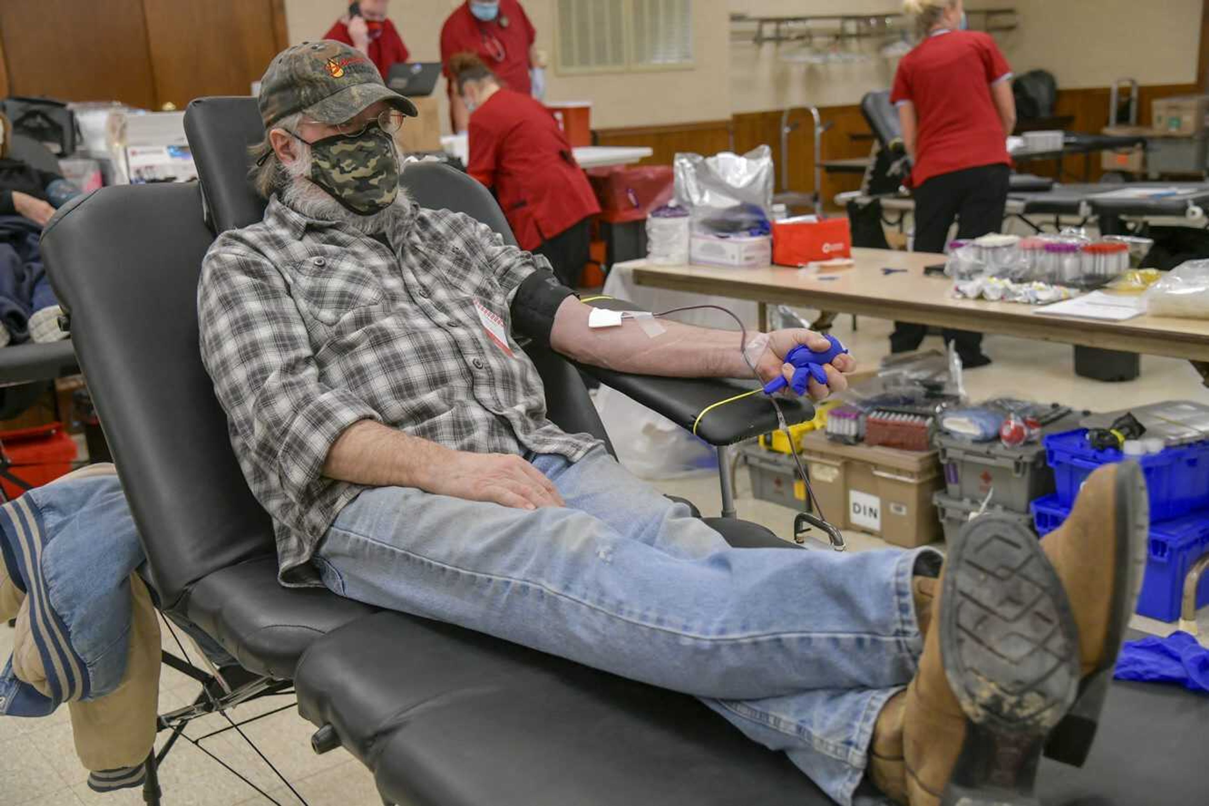 Donald Dannenmueller squeezes a rubber ball covered by a glove as he donates blood during an American Red Cross blood drive at the Knights of Columbus Council 6420 building Monday in Scott City. Dannenmueller said he has donated blood on a regular basis since the 1980s, and while he lost an exact count, he said this had to be over his 80th time donating. According to the organization's website, "The American Red Cross has a constant and ongoing need for blood and platelet donations. With the ongoing pandemic, the Red Cross needs the help of blood and platelet donors and blood drive hosts to meet the needs of patient care."