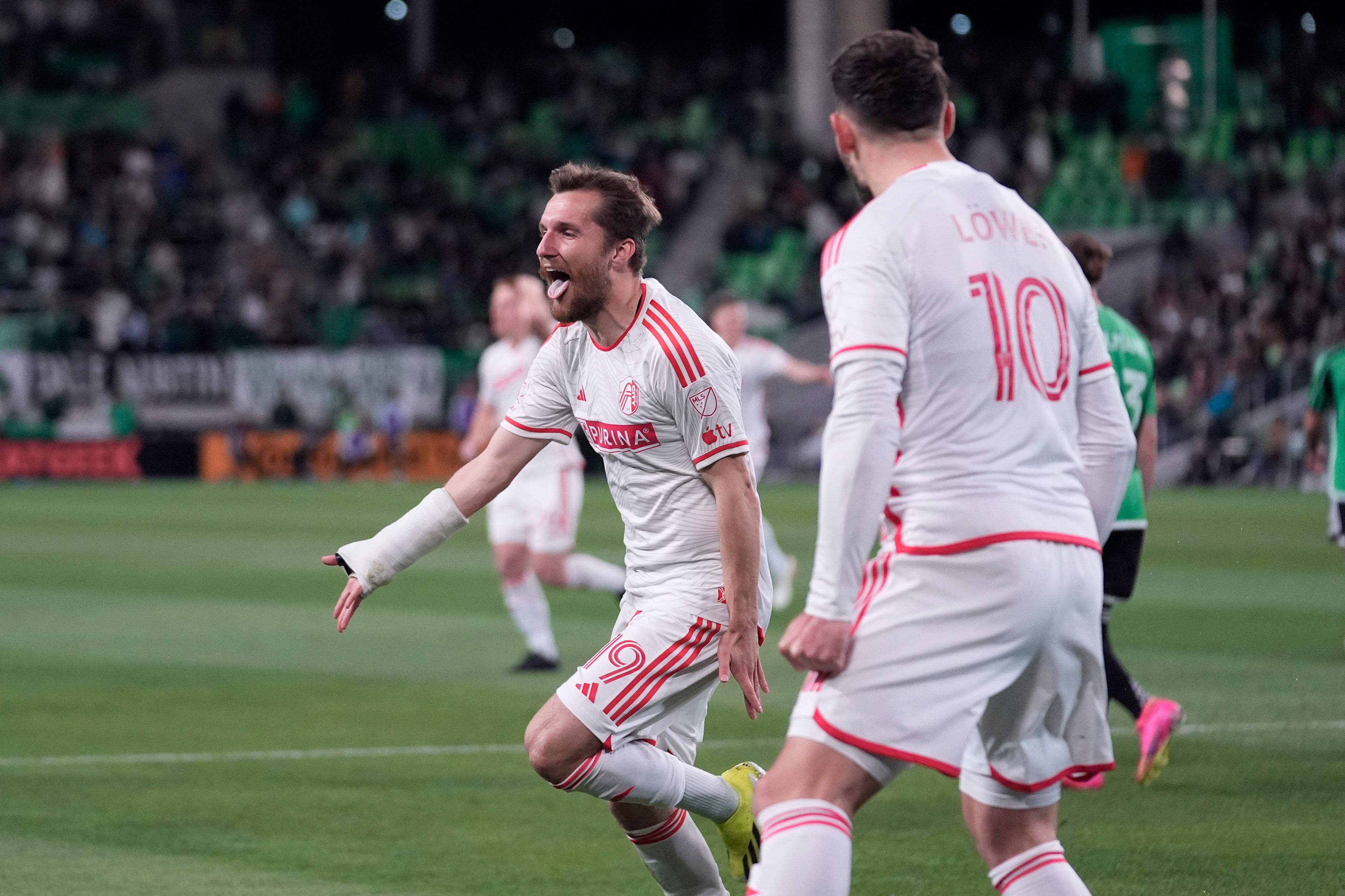 St. Louis City midfielder Indiana Vassilev (19) celebrates after teammate midfielder Eduard Lowen (10) scored against Austin FC during the second half of an MLS soccer match in Austin, Texas, Saturday, March 9, 2024. (AP Photo/Eric Gay)