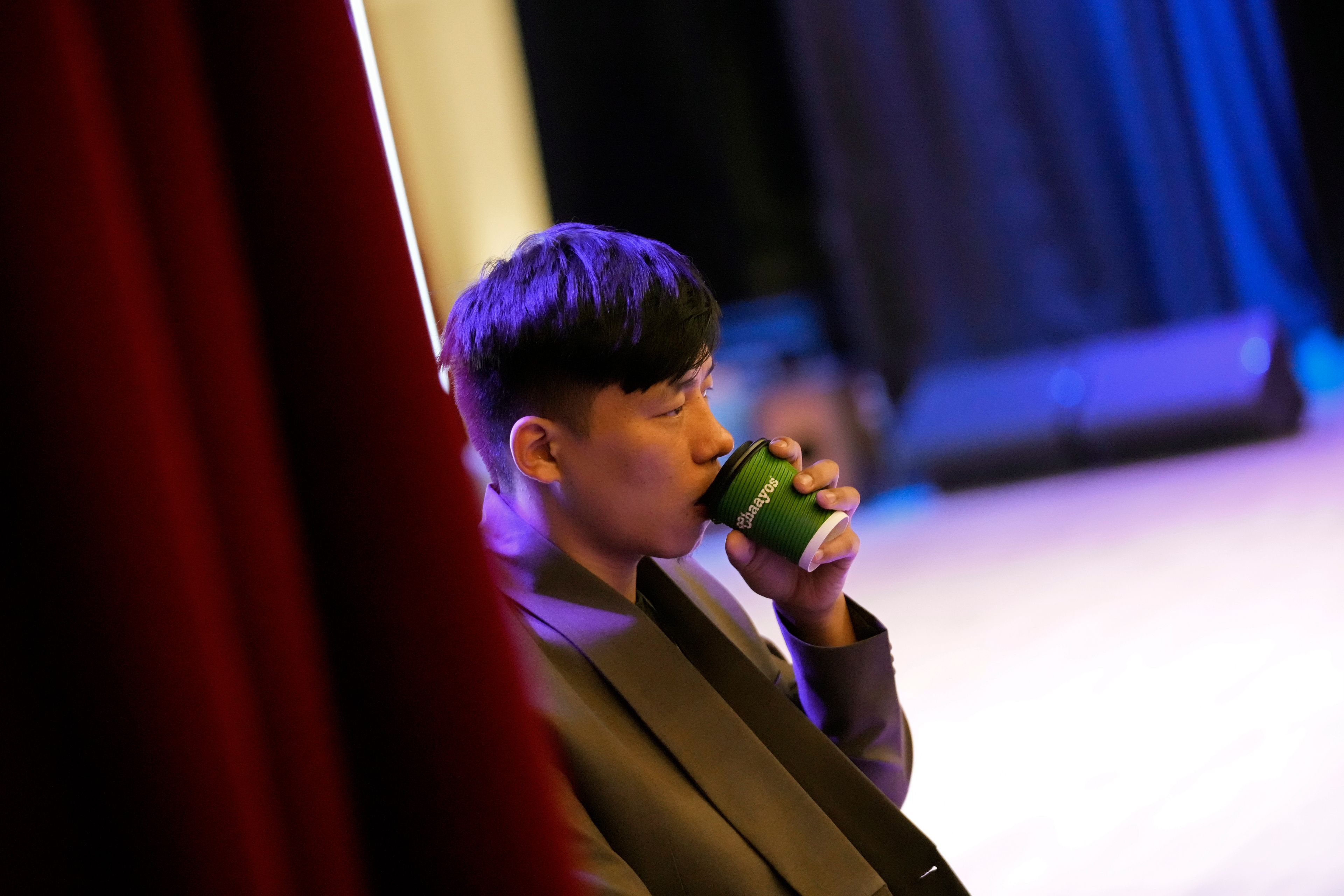 Takosangba Pongen, 27, a blind pianist, drinks tea as he waits for his turn to rehearse during the two-day Brillante Piano Festival in Bengaluru, India, Sunday, Sept. 29, 2024. (AP Photo/Aijaz Rahi)