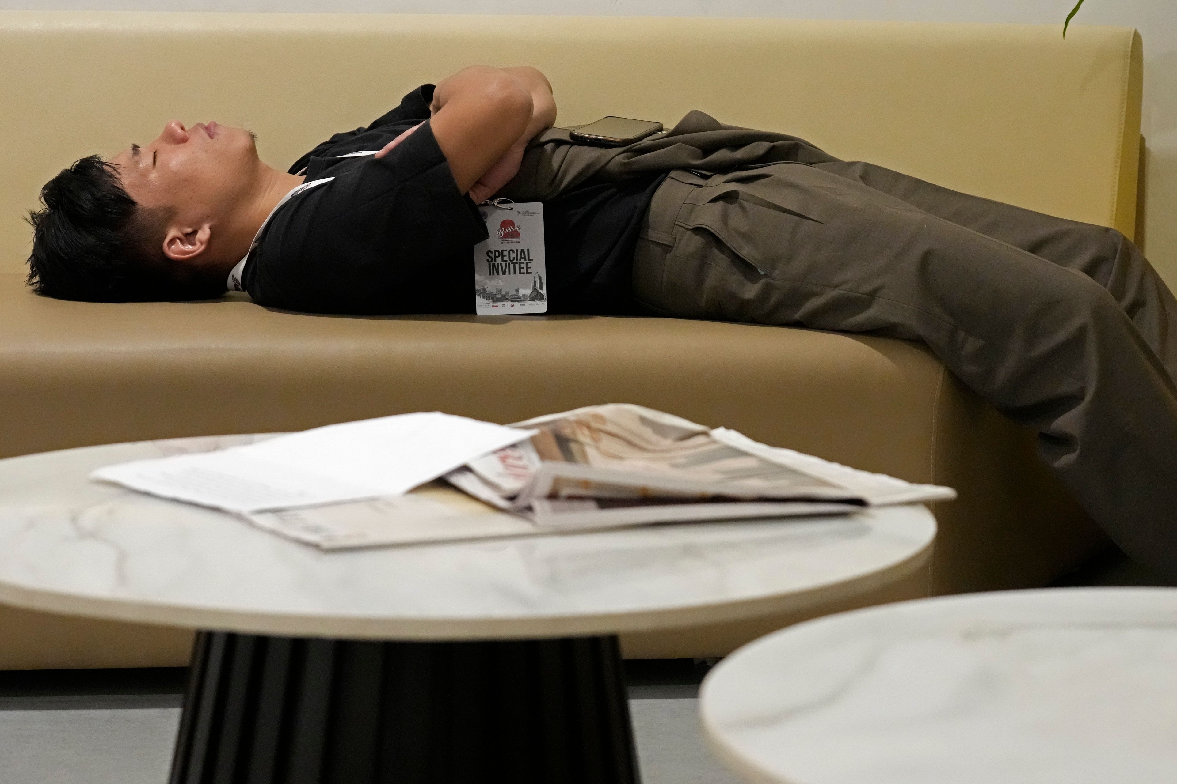 Takosangba Pongen, 27, a blind pianist, rests on a sofa in the green room before his performance at the two-day Brillante Piano Festival in Bengaluru, India, Sunday, Sept. 29, 2024. (AP Photo/Aijaz Rahi)