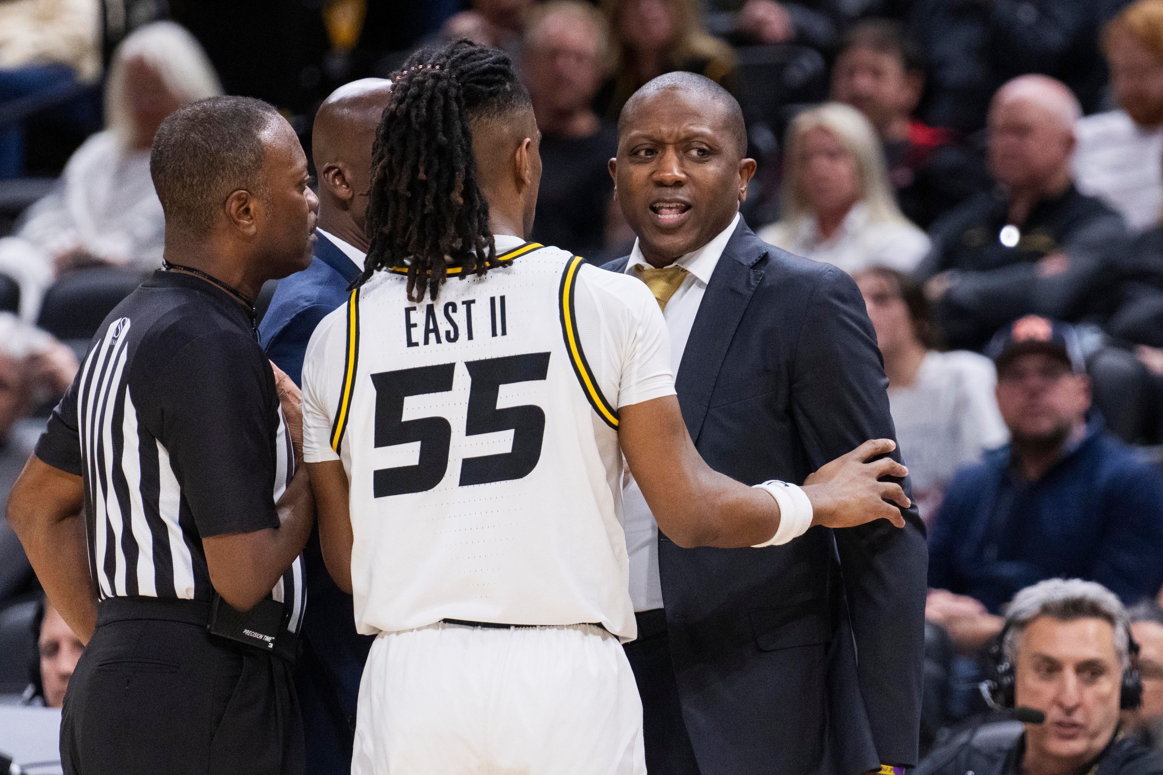 Missouri head coach Dennis Gates, right, is held back by Sean East II (55) after the bench had a technical foul called during the first half of an NCAA college basketball game against Auburn Tuesday, March 5, 2024, in Columbia, Mo. (AP Photo/L.G. Patterson)