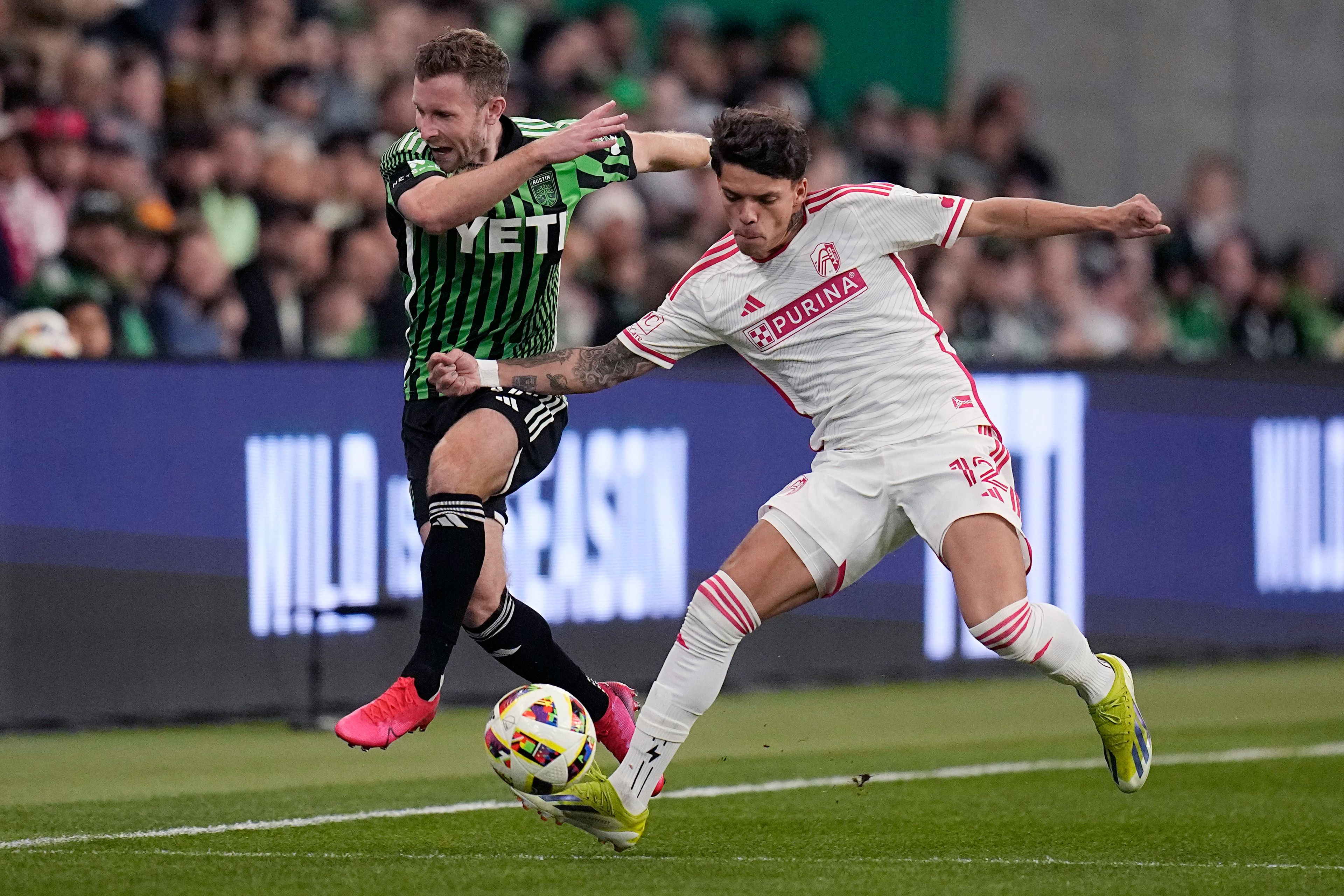 Austin FC forward Jon Gallagher (17) and St. Louis City midfielder Celio Pompeu (12) chase a pass during the first half of an MLS soccer match Saturday, March 9, 2024, in Austin, Texas. (AP Photo/Eric Gay)